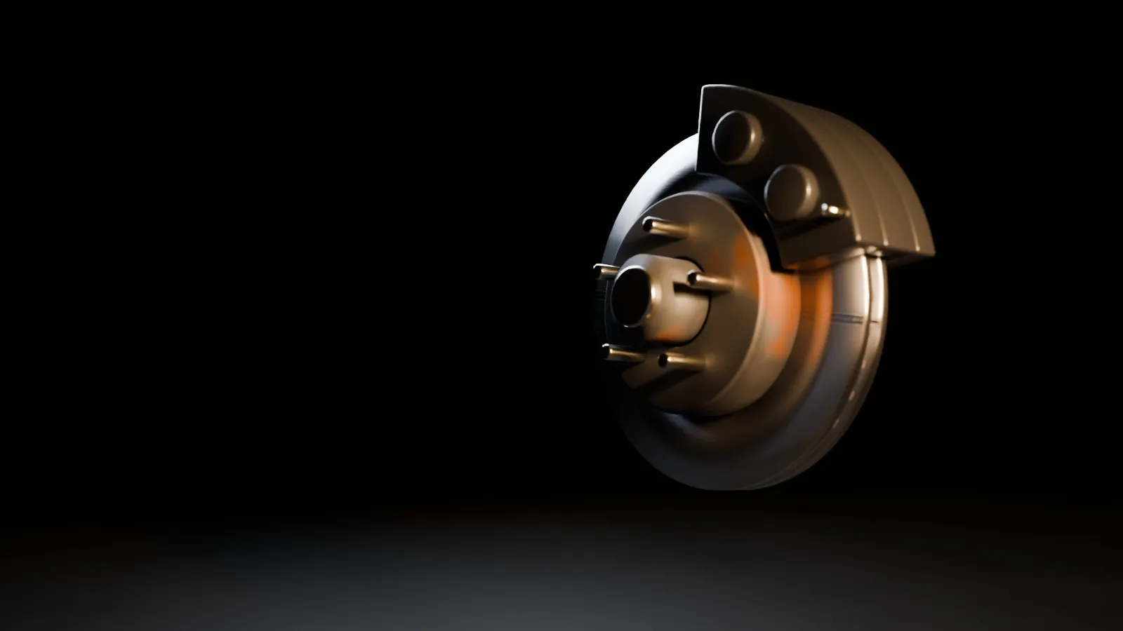 A brake rotor, caliper and hub under a work light