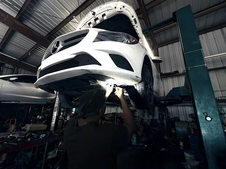 A car on the lift during an inspection at Front Line Auto